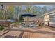 Relaxing backyard deck with outdoor furniture and a dining set with an umbrella at 235 Stafford Estates Dr, Salisbury, NC 28146