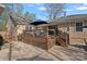 Wooden deck with railings and outdoor seating, with a concrete patio and stairs at 235 Stafford Estates Dr, Salisbury, NC 28146