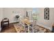 Bright dining room with wood floors, an elegant chandelier, and a large window at 235 Stafford Estates Dr, Salisbury, NC 28146