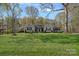 Charming brick home featuring a manicured front lawn and mature shade trees at 235 Stafford Estates Dr, Salisbury, NC 28146