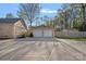 A two-car garage with white doors and a spacious parking pad at 235 Stafford Estates Dr, Salisbury, NC 28146