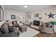 Cozy living room with a fireplace, comfortable seating, and ample natural light from french doors at 235 Stafford Estates Dr, Salisbury, NC 28146