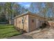 Outbuilding featuring horizontal siding, a small porch, and manicured landscaping at 235 Stafford Estates Dr, Salisbury, NC 28146