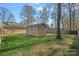 Backyard shed on a well maintained lawn with mature trees in a residential neighborhood at 235 Stafford Estates Dr, Salisbury, NC 28146