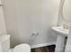 Half bath featuring modern fixtures, a pedestal sink, and wood-look flooring at 2557 Grantham Place Dr, Fort Mill, SC 29715