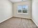 A room with carpeted floors, a window, and electrical outlets on the walls at 2557 Grantham Place Dr, Fort Mill, SC 29715