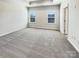 Primary bedroom featuring two windows and neutral carpet at 2557 Grantham Place Dr, Fort Mill, SC 29715