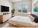 Cozy staged bedroom with a soft rug, natural light, and modern furnishings at 2557 Grantham Place Dr, Fort Mill, SC 29715