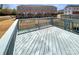 View of a wooden deck with a railing, overlooking an outdoor space and neighboring townhomes at 2557 Grantham Place Dr, Fort Mill, SC 29715