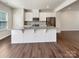 Well-lit kitchen featuring white cabinets, stainless appliances, and a granite countertop island at 2557 Grantham Place Dr, Fort Mill, SC 29715