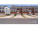 Attractive brick and gray sided townhomes with one-car garages and well-maintained landscaping at 2619 Grantham Place Dr, Fort Mill, SC 29715