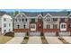Attractive brick and gray sided townhomes with one-car garages and well-maintained landscaping at 2619 Grantham Place Dr, Fort Mill, SC 29715