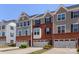 Attractive brick and gray sided townhomes with one-car garages and well-maintained landscaping at 2619 Grantham Place Dr, Fort Mill, SC 29715