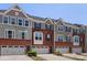 Attractive brick and gray sided townhomes with one-car garages and well-maintained landscaping at 2619 Grantham Place Dr, Fort Mill, SC 29715