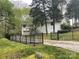Back of a white home with an upper deck, two-car garage, and fenced yard at 2701 Rea Rd, Charlotte, NC 28226