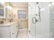 Bathroom featuring a tile shower, tiled floor, and dual sink vanity at 2701 Rea Rd, Charlotte, NC 28226