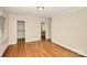 Bright bedroom features hardwood floors, neutral paint, and a convenient ensuite bathroom and closet at 2701 Rea Rd, Charlotte, NC 28226
