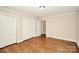 Bedroom featuring hardwood floors, neutral paint, and access to closets at 2701 Rea Rd, Charlotte, NC 28226