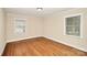 This cozy bedroom has hardwood floors, cream walls, white trim, and multiple windows for natural light at 2701 Rea Rd, Charlotte, NC 28226