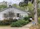 White brick home with meticulously landscaped yard and mature trees at 2701 Rea Rd, Charlotte, NC 28226