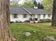 Charming white brick home with a well-manicured lawn and mature trees at 2701 Rea Rd, Charlotte, NC 28226