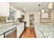 Bright kitchen featuring granite countertops, white cabinetry, and stainless steel appliances at 2701 Rea Rd, Charlotte, NC 28226