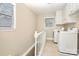 Bright laundry room with tile floors, built in cabinets, and two windows at 2701 Rea Rd, Charlotte, NC 28226