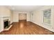 Bright living room featuring hardwood floors, a fireplace and large window views at 2701 Rea Rd, Charlotte, NC 28226