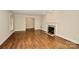 Living room with hardwood floors, fireplace and view into another room at 2701 Rea Rd, Charlotte, NC 28226