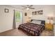 Comfortable bedroom with ceiling fan, natural light, and neutral decor at 2893 Yeager Nw Dr, Concord, NC 28027