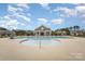 Large community pool featuring a splash pad, ample seating, and a pool house at 2893 Yeager Nw Dr, Concord, NC 28027