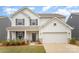 Charming two-story home with gray shutters, a covered porch, an attached garage and well-kept lawn at 2893 Yeager Nw Dr, Concord, NC 28027
