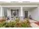 Inviting front porch with rocking chairs, decorative plants, and stacked stone pillar accents at 2893 Yeager Nw Dr, Concord, NC 28027