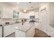 Bright kitchen with white cabinets, granite countertops, kitchen island, and stainless steel appliances at 2893 Yeager Nw Dr, Concord, NC 28027