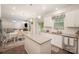Modern kitchen with white cabinets, granite countertops, stainless appliances and seamless access to the dining area at 2893 Yeager Nw Dr, Concord, NC 28027