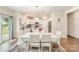 Open kitchen with white cabinetry, stainless steel appliances, and a dining area at 2893 Yeager Nw Dr, Concord, NC 28027