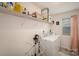 Bright laundry room with white washer and dryer, shelving, and natural light from the window at 2893 Yeager Nw Dr, Concord, NC 28027