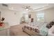 Spacious main bedroom featuring tray ceiling, fan, and a comfortable hanging chair at 2893 Yeager Nw Dr, Concord, NC 28027