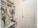 Functional mudroom with built-in storage bench and overhead shelving at 2893 Yeager Nw Dr, Concord, NC 28027