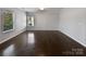 Spacious, bright room with gleaming hardwood floors and a large window, perfect for customization at 3026 S Devon St, Charlotte, NC 28213