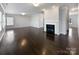A spacious living room with hardwood floors and a cozy fireplace, creating a warm and inviting atmosphere at 3026 S Devon St, Charlotte, NC 28213