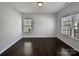 Bright room with hardwood floors, neutral paint, and natural light streaming through the white-framed windows at 3026 S Devon St, Charlotte, NC 28213