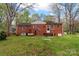 Rear exterior view showcasing the brick home, yard, and patio entrance at 304 Simrill Ave, York, SC 29745