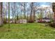 Large backyard with shed and mature trees, creating a private and serene outdoor space at 304 Simrill Ave, York, SC 29745