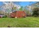 Exterior rear view of a charming brick home with a spacious yard and mature trees at 304 Simrill Ave, York, SC 29745