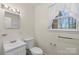Bright bathroom with a modern sink, toilet, and a window providing natural light at 304 Simrill Ave, York, SC 29745