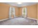 Spacious bedroom with neutral carpet, two large windows letting in ample natural light at 304 Simrill Ave, York, SC 29745