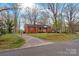 Traditional red brick home with driveway and mature trees offering shade and curb appeal at 304 Simrill Ave, York, SC 29745