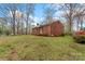 Red brick home with mature trees, well-kept lawn, and colorful azaleas near the entrance at 304 Simrill Ave, York, SC 29745