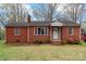 Charming red brick home featuring a classic design, a well-kept lawn, and a cozy front porch at 304 Simrill Ave, York, SC 29745